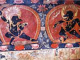 Tibet Guge 09 Tsaparang Demchog Temple 08 Hidden Vajravarahi Attendants Below the Demchog Mandala Temple is a small windowless temple, its walls covered with good paintings. Th�ni calls it the Hidden Temple (Verborgnen in German). Here is a painting of two attendants to Vajravarahi (Tib. Dorje Phagmo), the left with what looks like the head of an eagle, and the right with the head of a pig, each holding a vajra-topped chopper and skull cup. Photo - Th�ni: Westtibet.